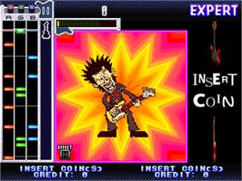 In game image of Guitar Freaks on the Arcade.